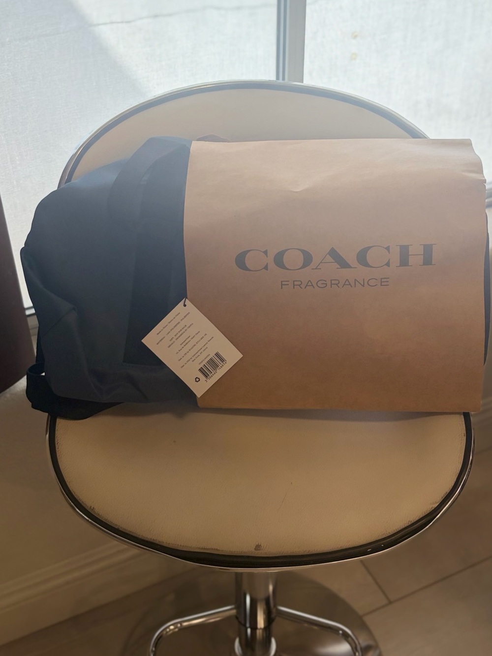 Coach Black Duffel Bag with Tan Paper Sleeve